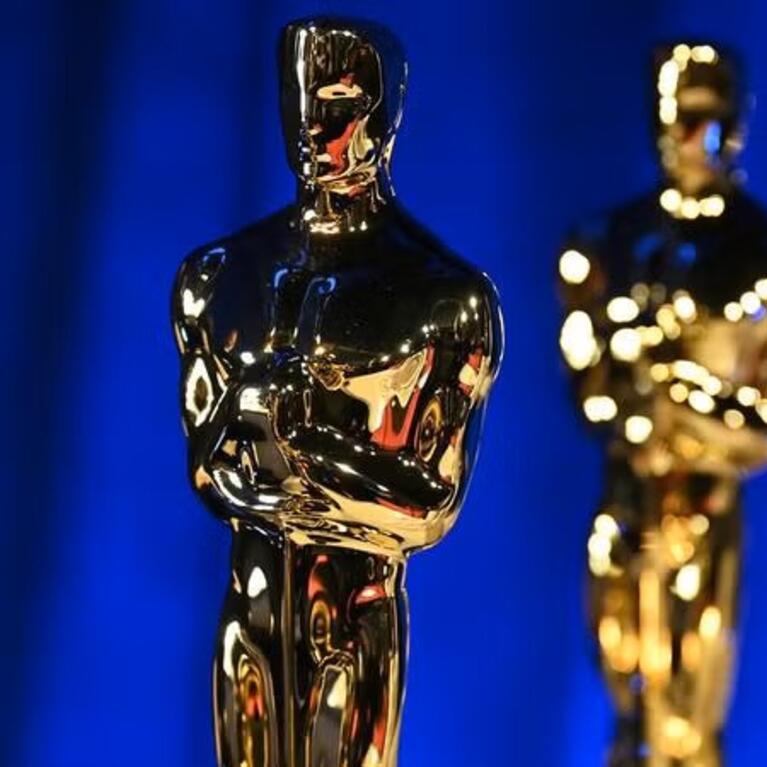 Lineup of Oscars awards on a blue background
