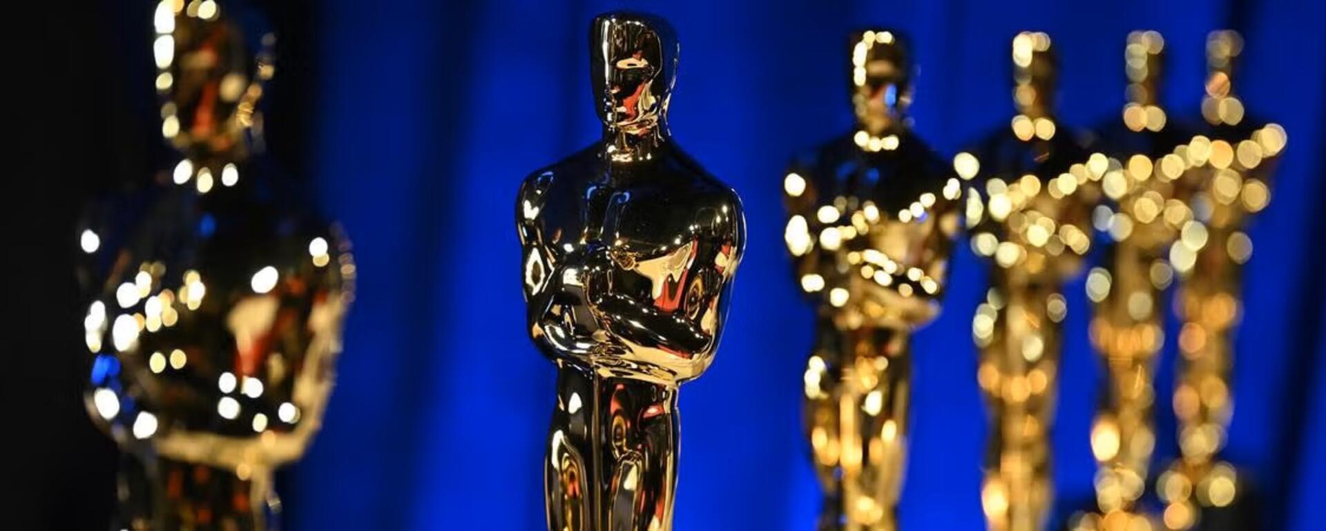 Lineup of Oscars awards on a blue background