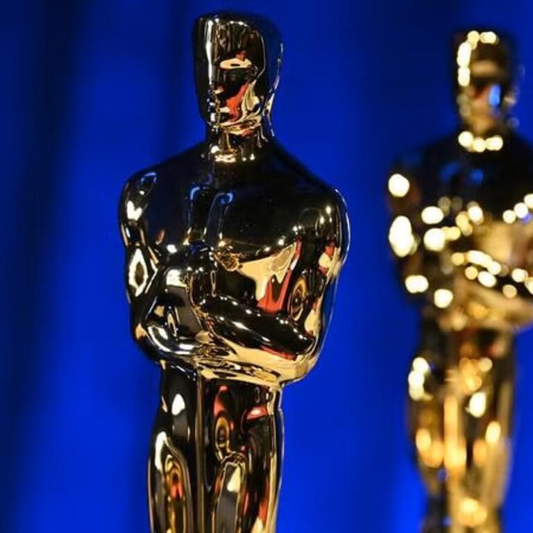 Lineup of Oscars awards on a blue background